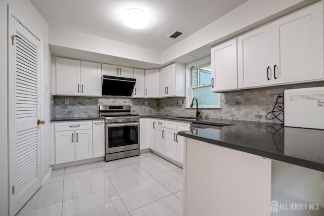 58 La Rue Ln, East Brunswick, NJ 08816 - kitchen with stainless steel range with gas cooktop, exhaust hood, dark countertops, and white cabinets