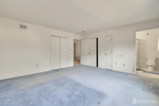 136 Carroll Ave, Woodbridge Proper, NJ 07095 - unfurnished bedroom with carpet floors, two closets, and connected bathroom