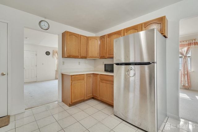 136 Carroll Ave, Woodbridge Proper, NJ 07095 - kitchen with freestanding refrigerator, light carpet, light countertops, and light tile patterned floors