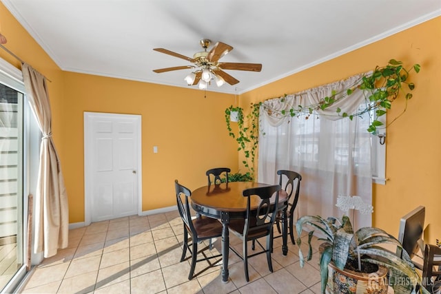 dining space featuring light tile patterned floors, baseboards, ceiling fan, and crown molding