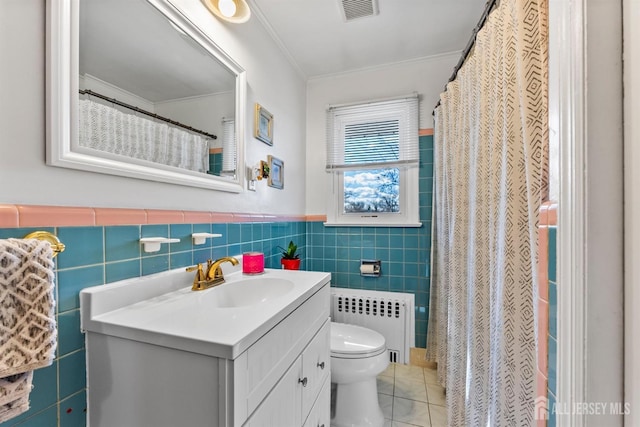 bathroom with tile patterned flooring, visible vents, radiator, toilet, and tile walls