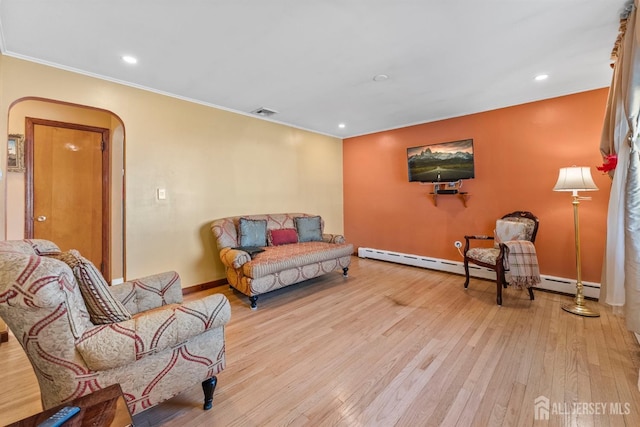 living room with wood finished floors, visible vents, recessed lighting, arched walkways, and ornamental molding