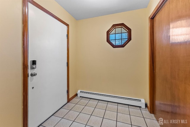 entryway with light tile patterned floors and a baseboard heating unit