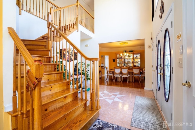 entrance foyer featuring a high ceiling and an inviting chandelier