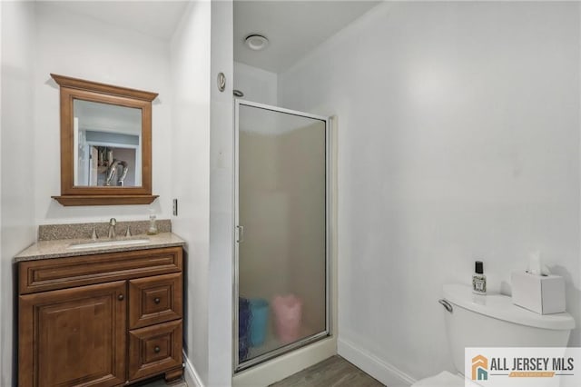321 Snowgoose Ln, Harrison, NJ 08062 - full bath with a stall shower, baseboards, toilet, vanity, and wood finished floors