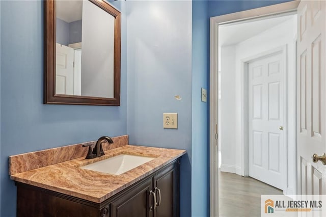 bathroom with vanity and wood-type flooring