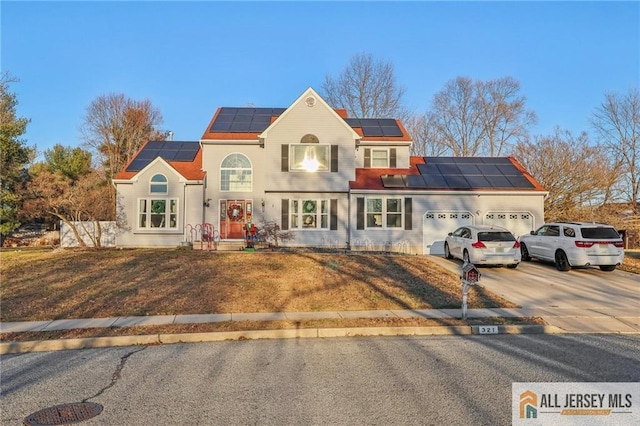 view of front of home featuring solar panels and a garage