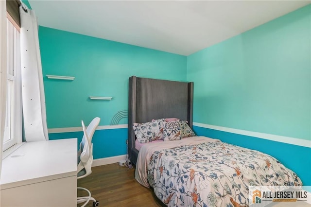 bedroom with dark hardwood / wood-style flooring