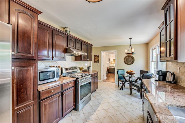 4 Hollis Rd, East Brunswick, NJ 08816 - kitchen featuring stainless steel appliances, under cabinet range hood, backsplash, glass insert cabinets, and light stone counters