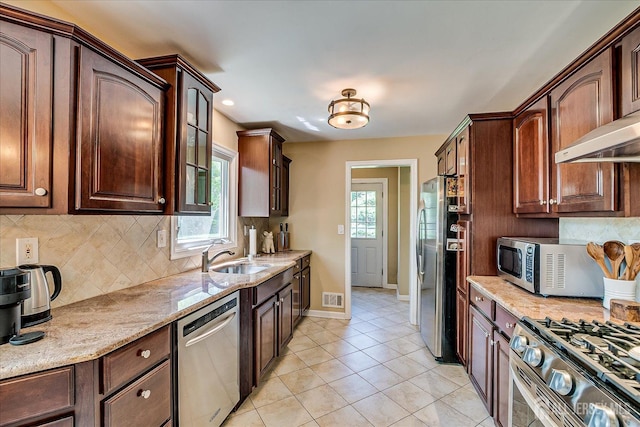 4 Hollis Rd, East Brunswick, NJ 08816 - kitchen with stainless steel appliances, decorative backsplash, light stone countertops, dark brown cabinets, and recessed lighting