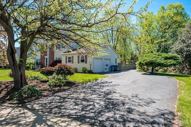 4 Hollis Rd, East Brunswick, NJ 08816 - view of front of home featuring asphalt driveway and an attached garage