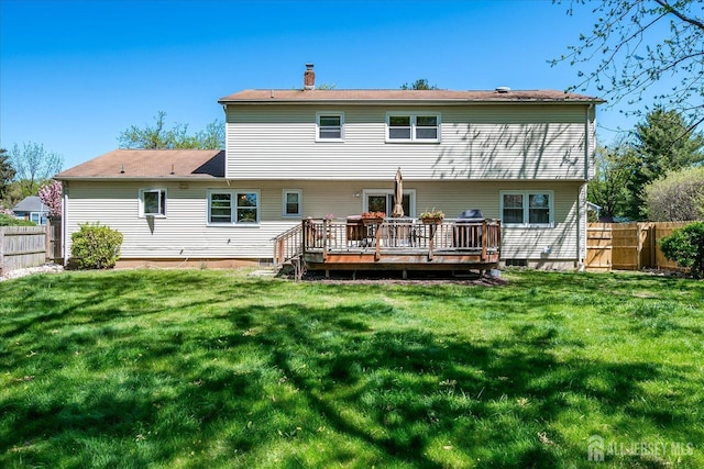 4 Hollis Rd, East Brunswick, NJ 08816 - rear view of house with a deck, a fenced backyard, and a chimney
