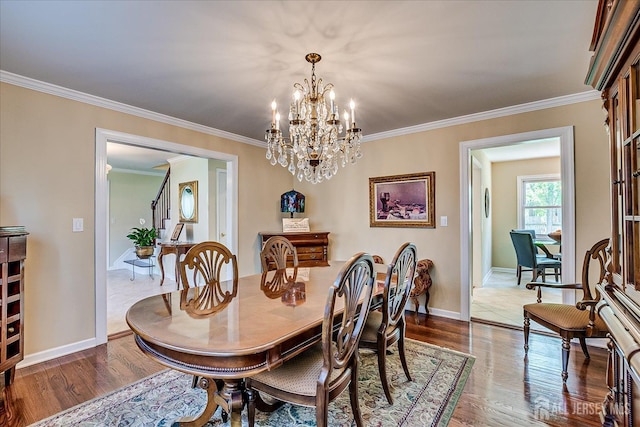 4 Hollis Rd, East Brunswick, NJ 08816 - dining area with wood finished floors, crown molding, a chandelier, and stairs
