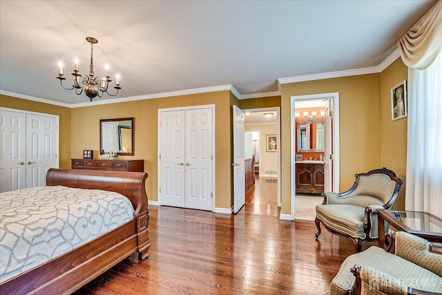 4 Hollis Rd, East Brunswick, NJ 08816 - bedroom featuring a chandelier, dark wood-type flooring, two closets, crown molding, and connected bathroom