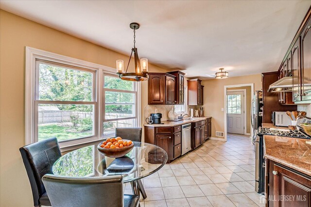 4 Hollis Rd, East Brunswick, NJ 08816 - kitchen featuring appliances with stainless steel finishes, light tile patterned flooring, under cabinet range hood, and dark brown cabinetry