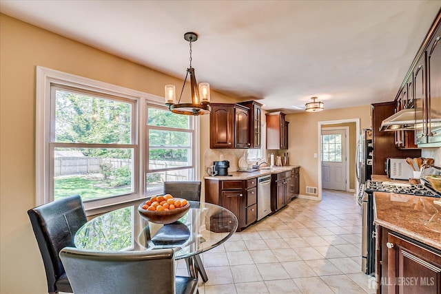 4 Hollis Rd, East Brunswick, NJ 08816 - kitchen with stainless steel appliances, light tile patterned floors, under cabinet range hood, and dark brown cabinetry