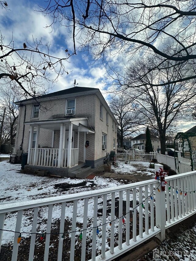 view of snow covered exterior featuring covered porch