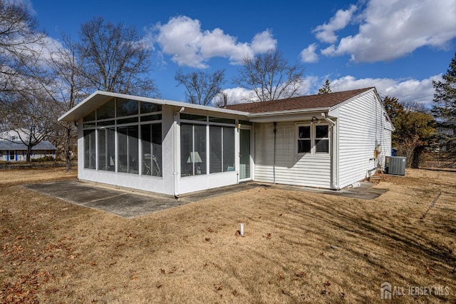 back of property with cooling unit, a yard, and a sunroom