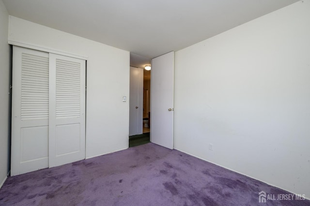 unfurnished bedroom with a closet and carpet