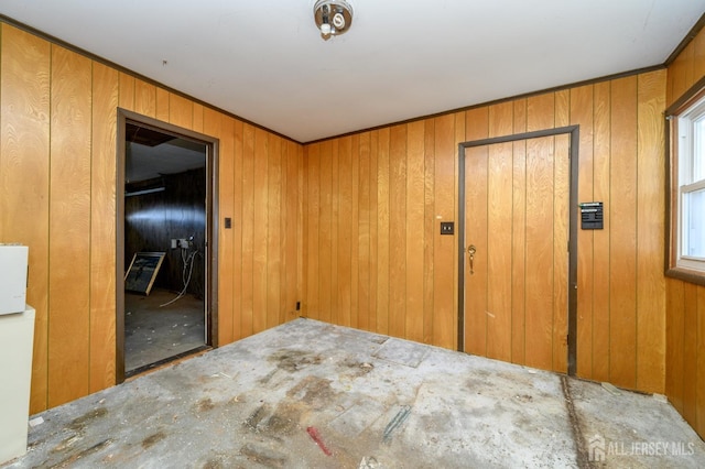 empty room featuring wooden walls