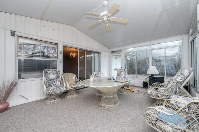 sunroom / solarium with a wealth of natural light, a ceiling fan, and vaulted ceiling