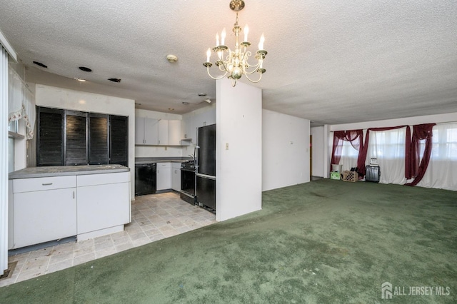 unfurnished living room with a notable chandelier, light colored carpet, and a textured ceiling