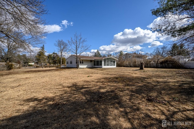 exterior space featuring a front lawn and a sunroom