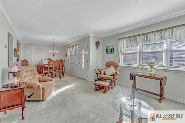 living area featuring ornamental molding, light carpet, a notable chandelier, and baseboards