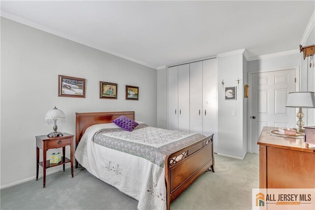 bedroom featuring light carpet, a closet, and crown molding