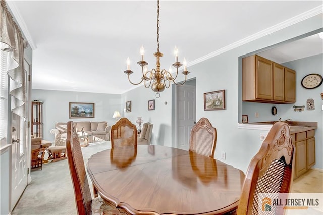 dining area with a chandelier, ornamental molding, and light colored carpet