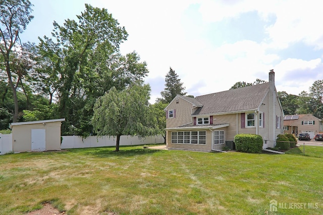 1270 S 9th St S, South Plainfield, NJ 07080 - rear view of property featuring a chimney and a fenced backyard