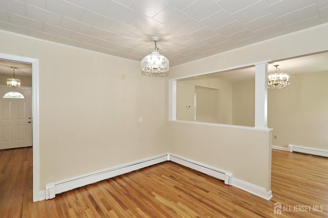 1270 S 9th St S, South Plainfield, NJ 07080 - unfurnished dining area featuring a chandelier, wood finished floors, a baseboard heating unit, and ornamental molding