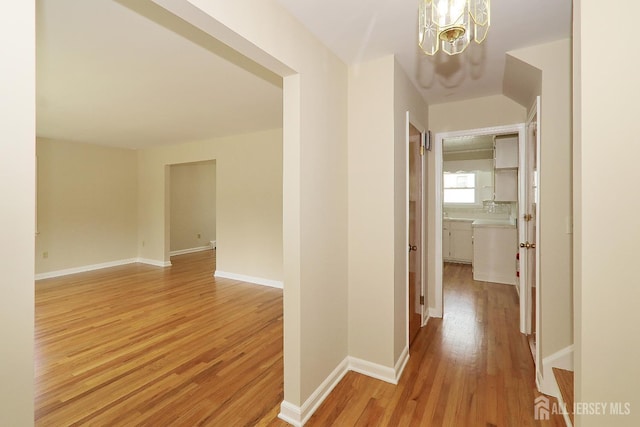 1270 S 9th St S, South Plainfield, NJ 07080 - hall featuring light wood-style flooring and a chandelier