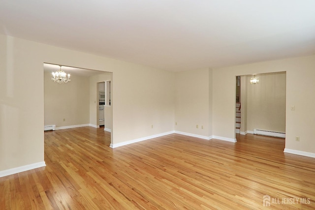1270 S 9th St S, South Plainfield, NJ 07080 - empty room with a chandelier, light wood finished floors, and baseboard heating