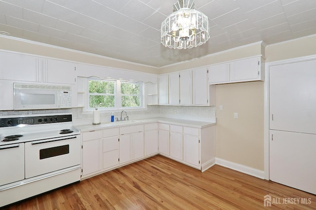 1270 S 9th St S, South Plainfield, NJ 07080 - kitchen featuring white appliances, a chandelier, ornamental molding, tasteful backsplash, and white cabinetry
