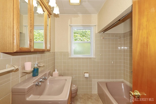 1270 S 9th St S, South Plainfield, NJ 07080 - bathroom with tile patterned flooring, tile walls, washtub / shower combination, and wainscoting