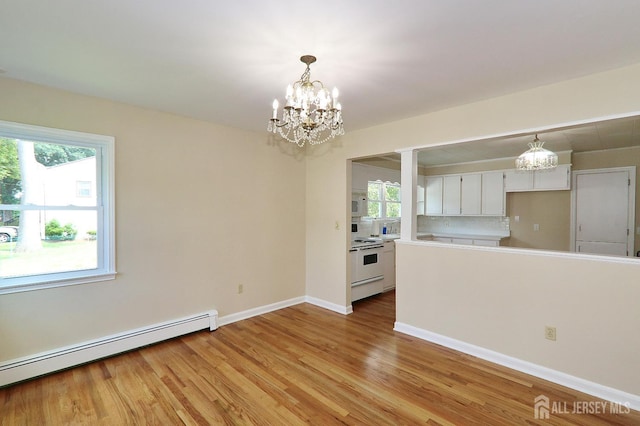 1270 S 9th St S, South Plainfield, NJ 07080 - kitchen with a chandelier, white cabinets, healthy amount of natural light, and light wood-style flooring