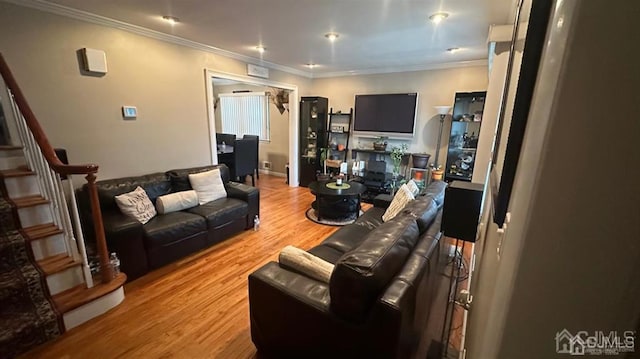 living room featuring ornamental molding and wood-type flooring