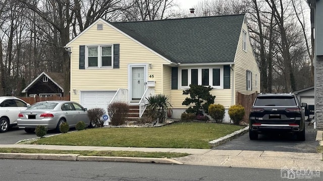 view of front of house with a garage and a front yard