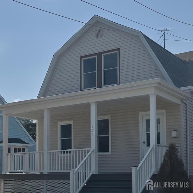 617 Lee St, Perth Amboy, NJ 08861 - colonial inspired home featuring a gambrel roof and a porch