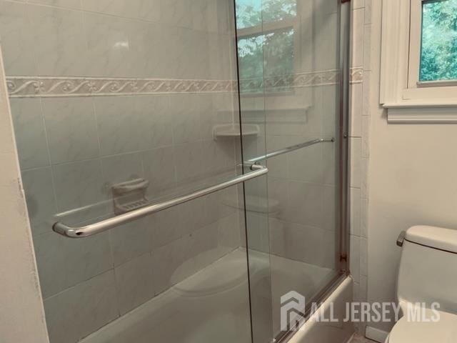 8 Indiana Ct Unit D, Old Bridge, NJ 07747 - bathroom featuring toilet and combined bath / shower with glass door