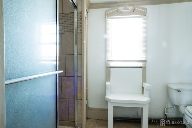 full bath featuring a shower stall, toilet, and tile patterned floors