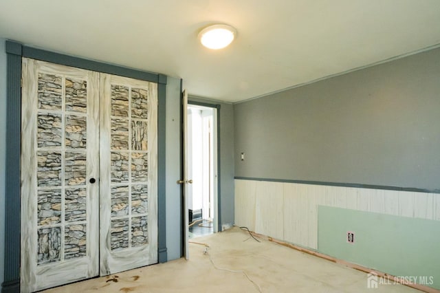 spare room with wainscoting