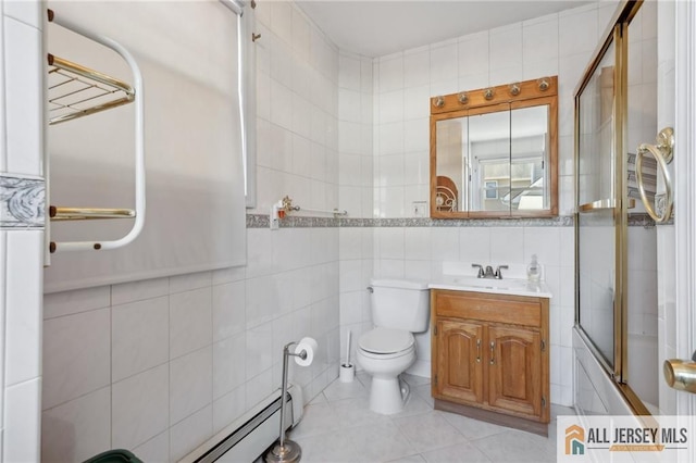 bathroom featuring vanity, tile walls, toilet, and combined bath / shower with glass door