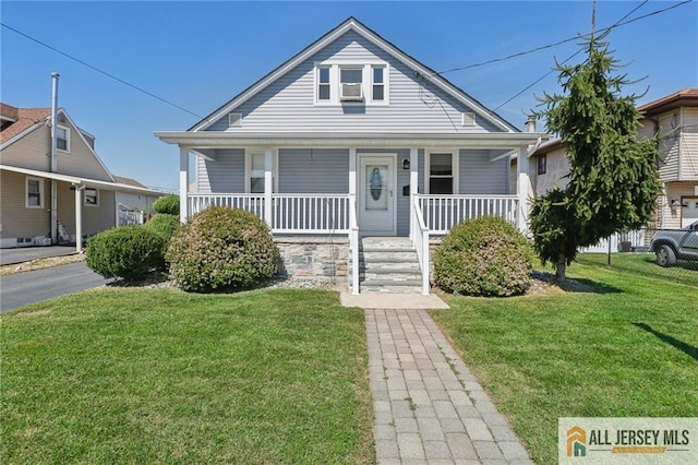 bungalow-style home featuring a porch and a front yard