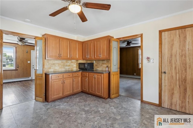 kitchen featuring brown cabinetry, a baseboard heating unit, and ornamental molding