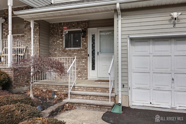 property entrance with brick siding and a porch