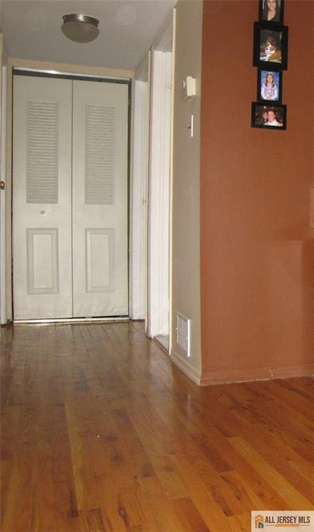 903 N Oaks Blvd, North Brunswick, NJ 08902 - hallway with wood finished floors and baseboards