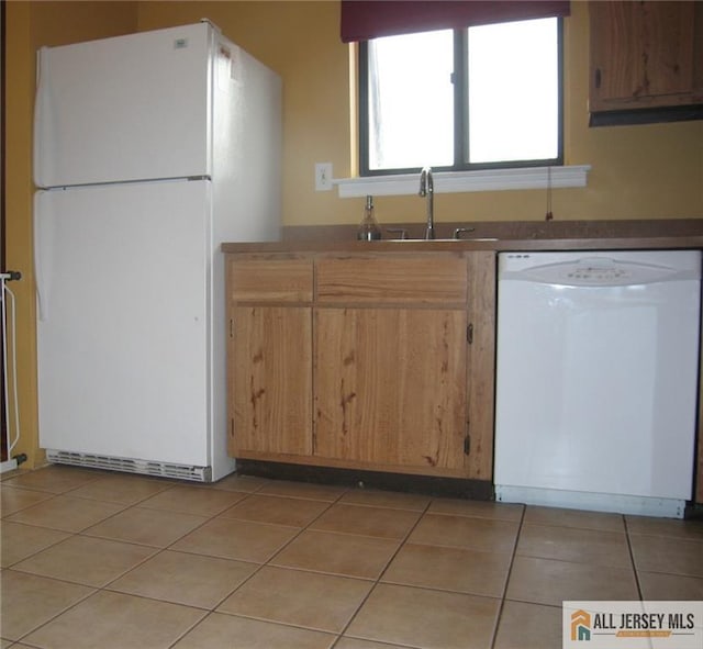 903 N Oaks Blvd, North Brunswick, NJ 08902 - kitchen with white appliances and light tile patterned floors
