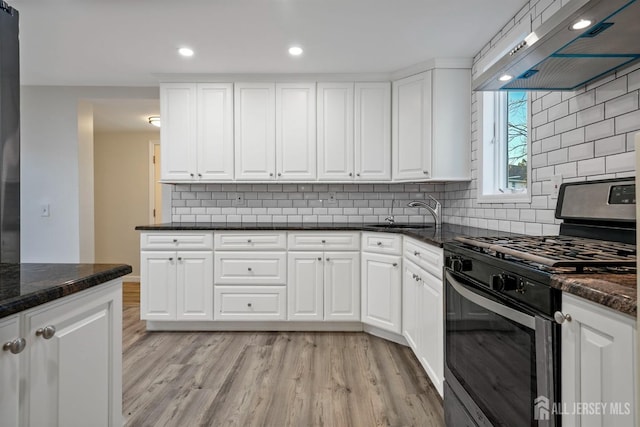 kitchen featuring white cabinetry, extractor fan, and stainless steel range with gas stovetop